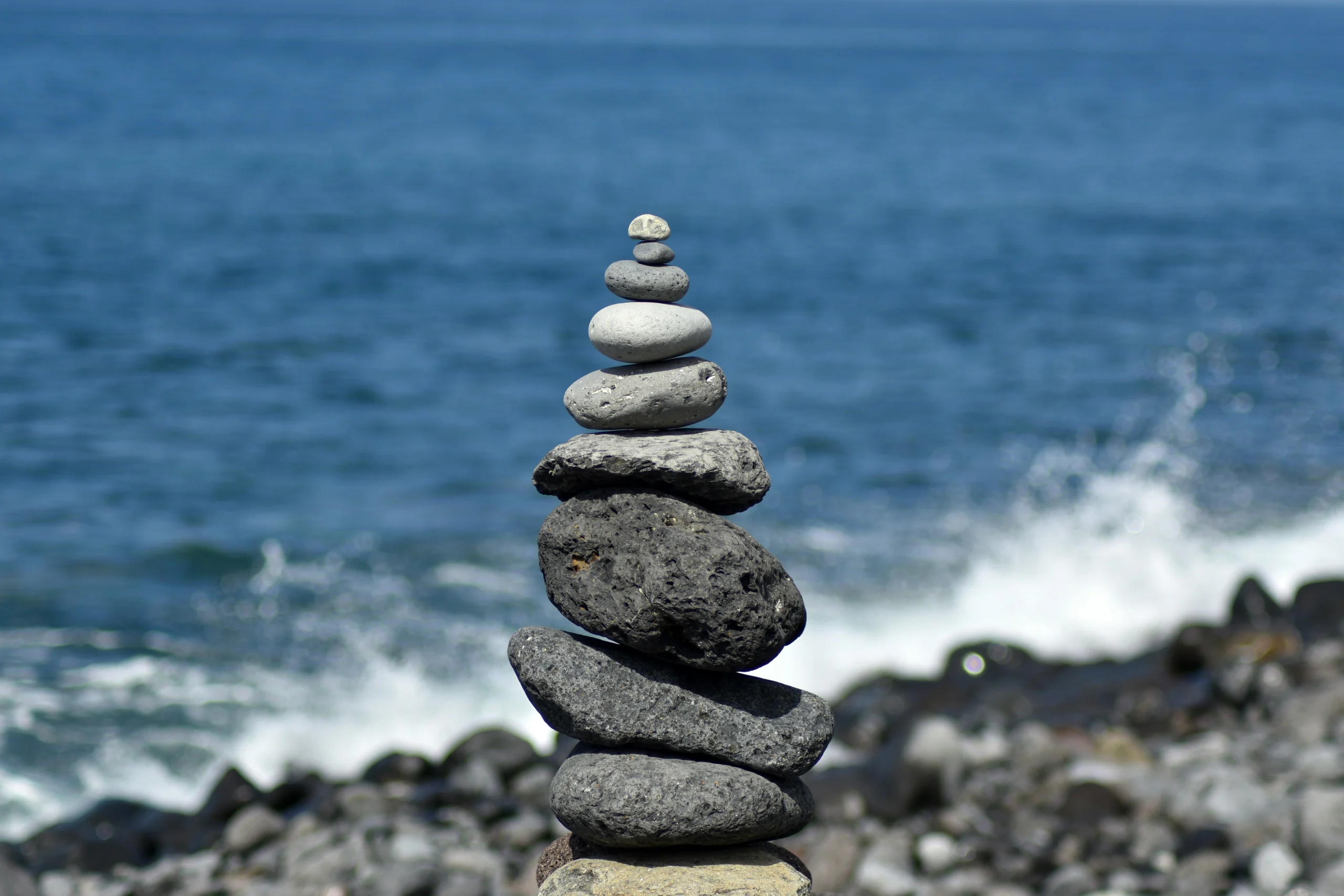 Stacked stones balanced on a stony shore